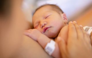 A Newborn Baby Being Held