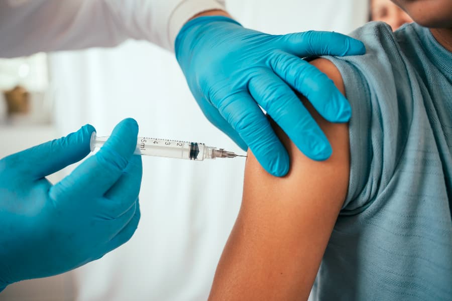 Practitioner administering vaccine to child